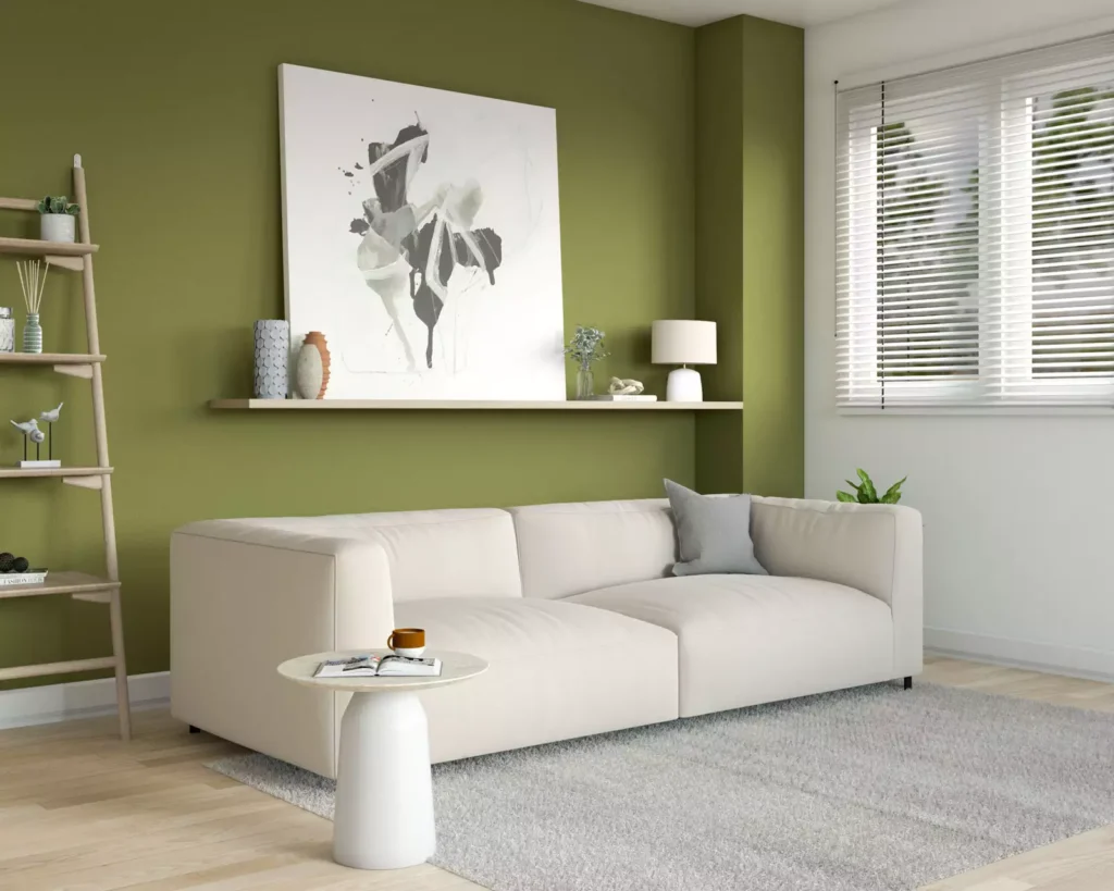 Modern living room with olive green walls, cream sofa, and oversized abstract art