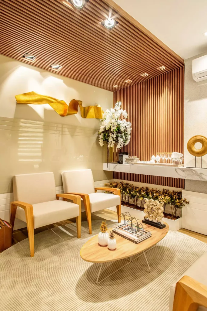 Modern tan wall living room lounge with wood slat paneling and a gold sculptural accent