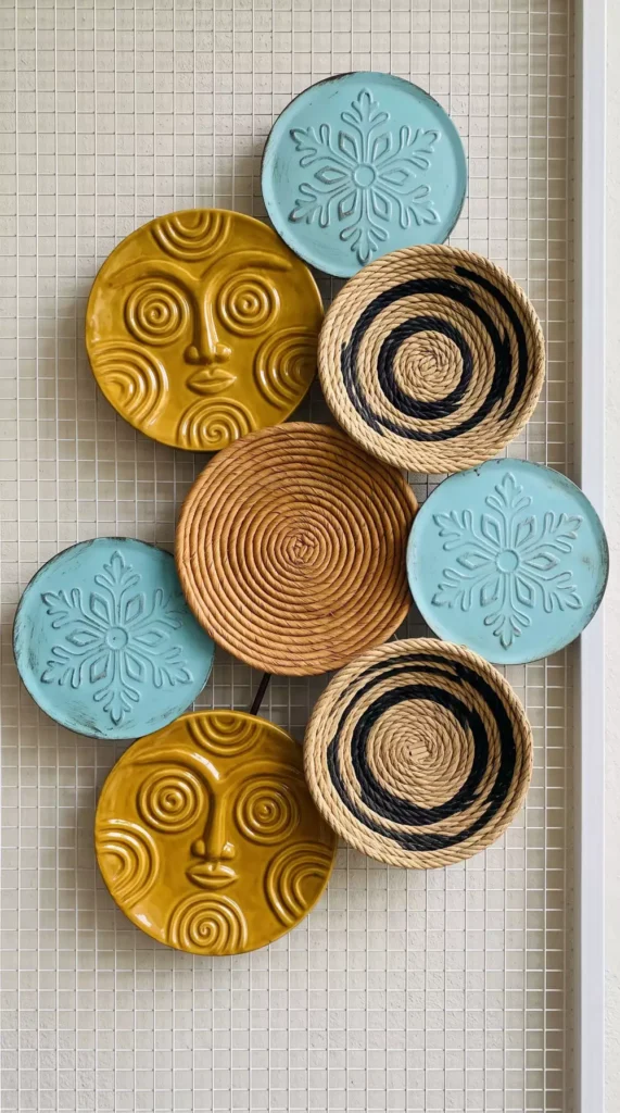 Mustard, teal, and woven circular wall decor with face and snowflake motifs
