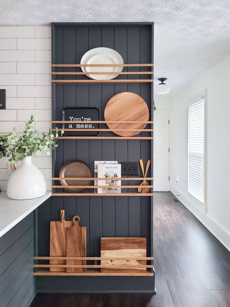 Navy plate rack kitchen wall holding boards, plates, and cookbooks