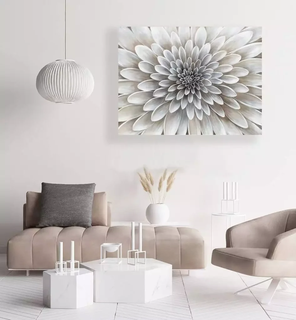 Oversized white dahlia flower canvas painting above a taupe sofa in a modern living room