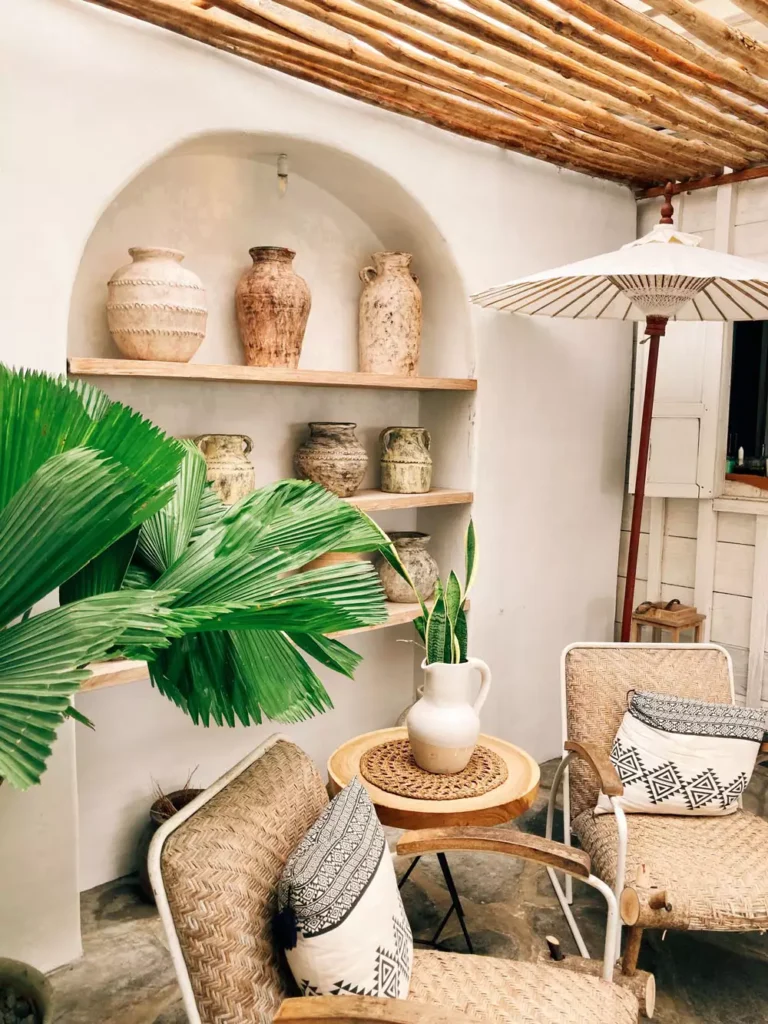 Patio Wall Arch Shelf Lined With Rustic Clay Pots And A Palm Frond
