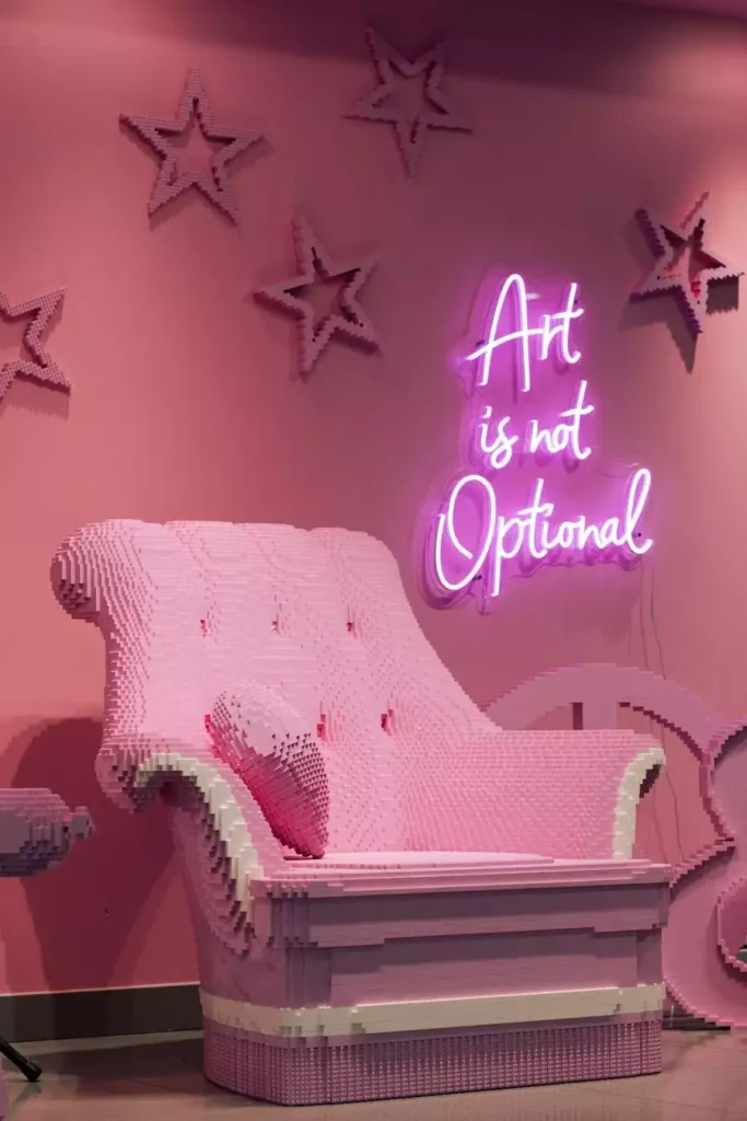 Pink Wall Decor Lounge With A Neon Art Sign And Star Accents