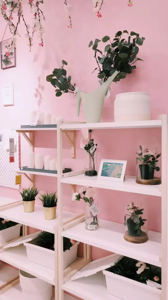Pink Wall Decor Shelving Display With Faux Greenery And Candles
