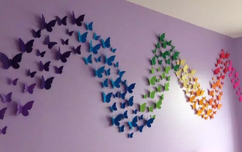 Rainbow-gradient paper Butterfly Wall wave sweeping across a lilac corner