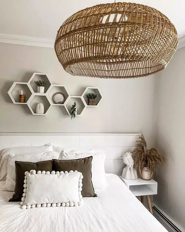 Rattan pendant light and honeycomb wall shelves styled as over the bed wall decor