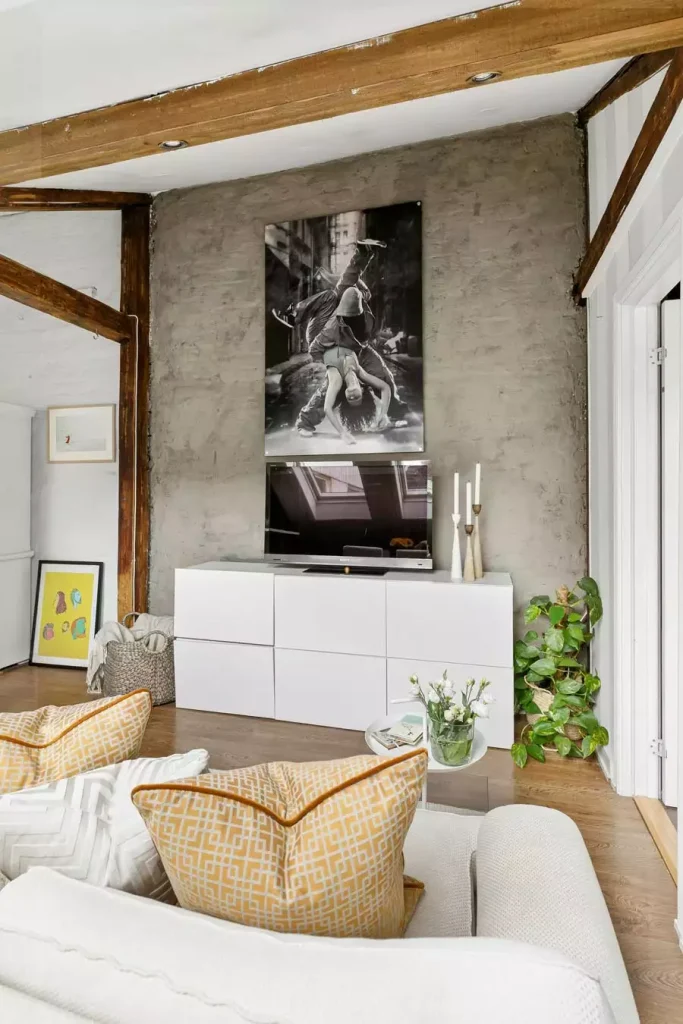 Rustic Concrete TV Wall With Framed Dance Photo And White Media Console