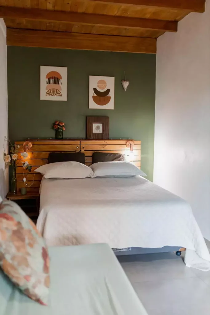 Rustic Green Wall With Wood Beam Ceiling And Framed Art