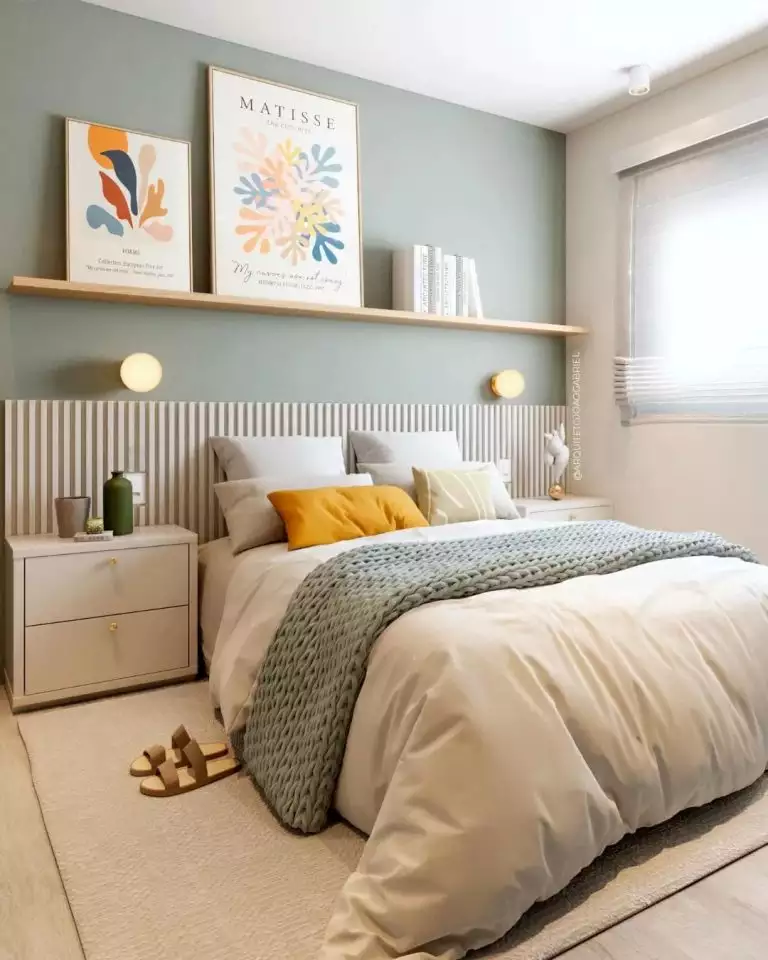 Sage green bedroom using a floating shelf with framed prints as over the bed wall decor