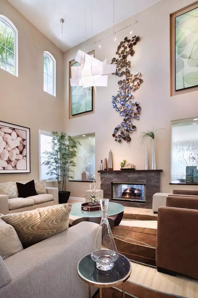 Sculptural mixed-media wall art above fireplace in vaulted living room