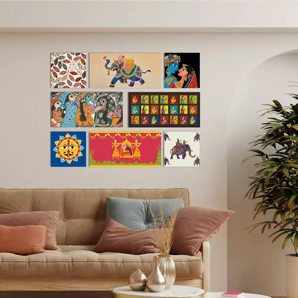 Set of 8 Indian wall decor canvas prints featuring elephants, Radha Krishna, and Madhubani motifs above a beige sofa