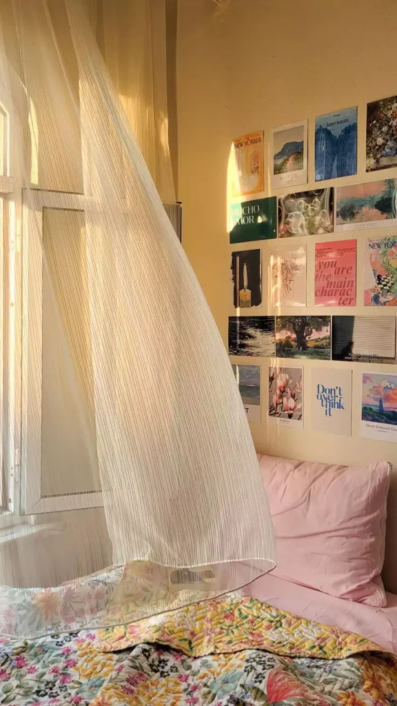 Sheer Curtain And A Postcard Art Grid Bring Dreamy Dorm Wall Decor Beside A Pink Pillow Bed
