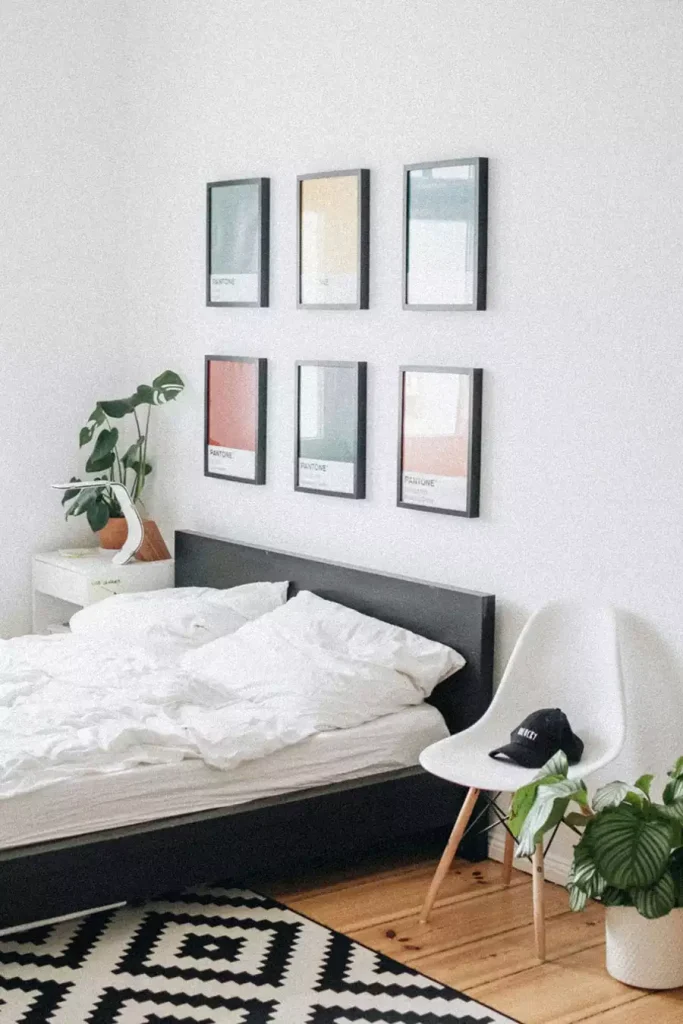 Six Framed Color Swatch Prints As Small Bedroom Wall Decor Above A Black Bed Frame