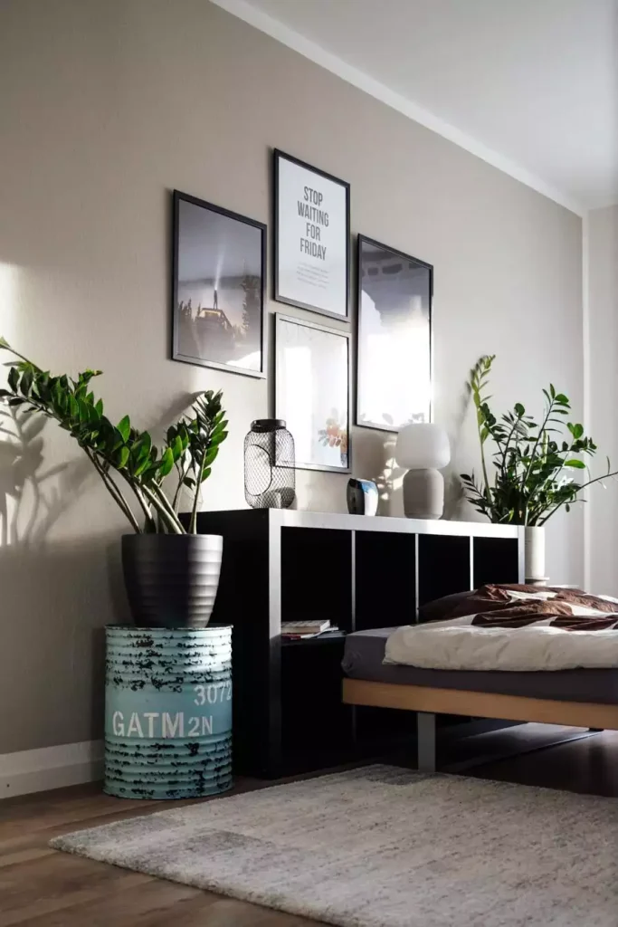  Small Bedroom Wall Decor Gallery With Black Framed Posters Above A Shelf And Potted Plants
