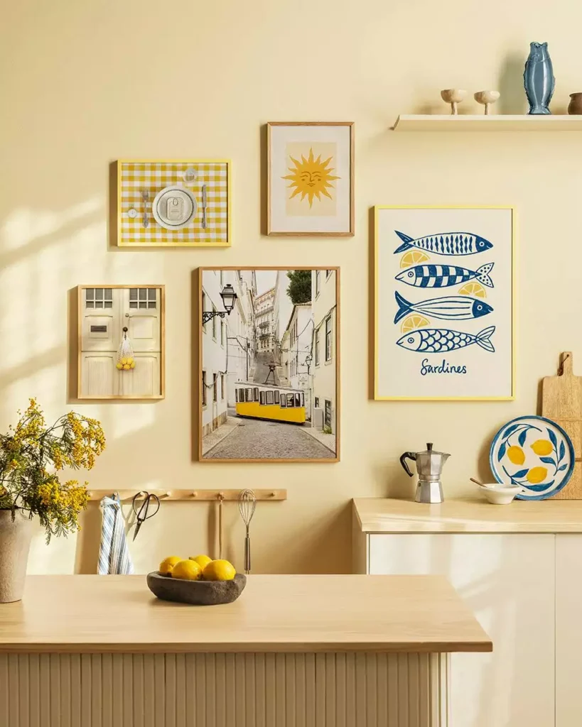 Sunny kitchen wall gallery with sardine print, yellow tram photo, and lemon bowl