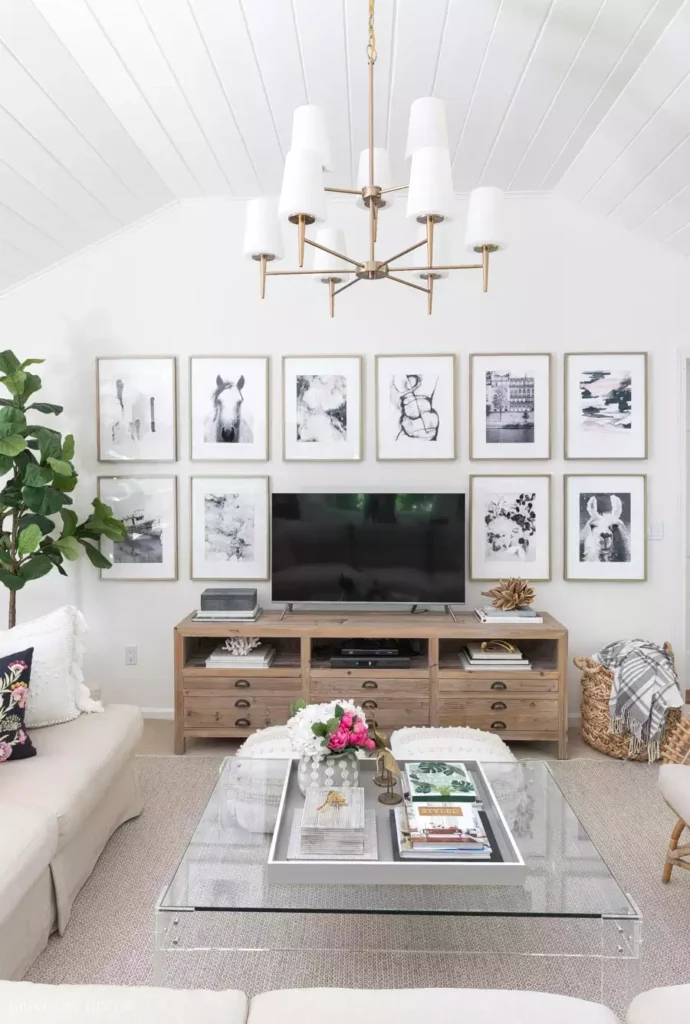 Symmetrical black-and-white gallery wall decor above TV console in living room