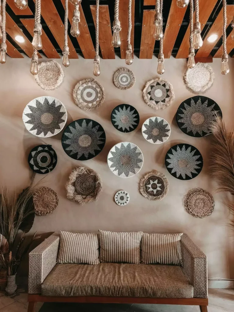 Tan above sofa wall packed with woven baskets over a rattan sofa