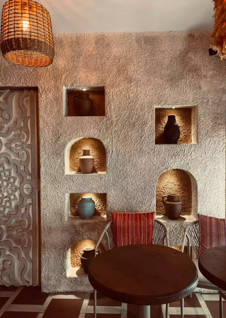 Textured Plaster Wall Arches Displaying Dark Clay Jugs