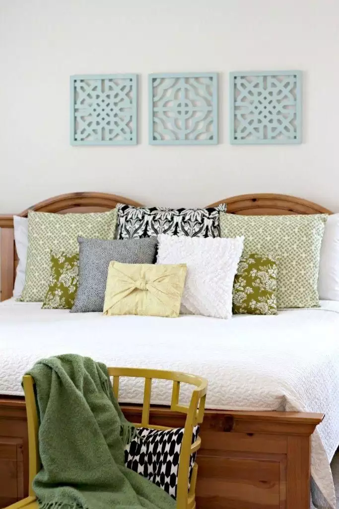 Three mint carved wood panels as Scandinavian style over the bed wall decor