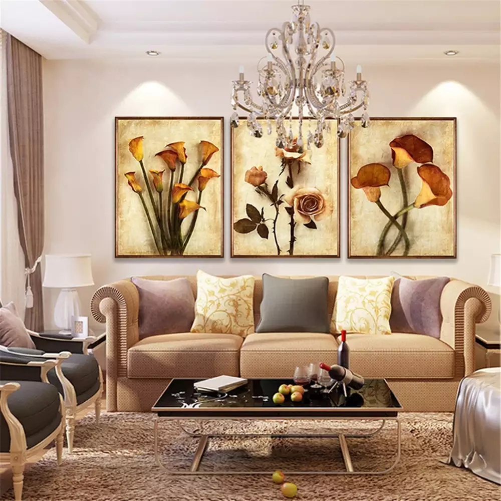 Three-panel floral canvas wall art above tan sofa in living room