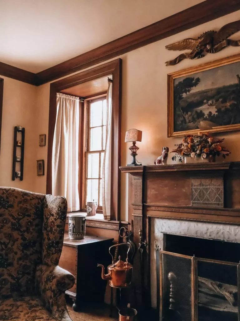 Traditional tan wall living room with dark wood trim and a carved fireplace mantel