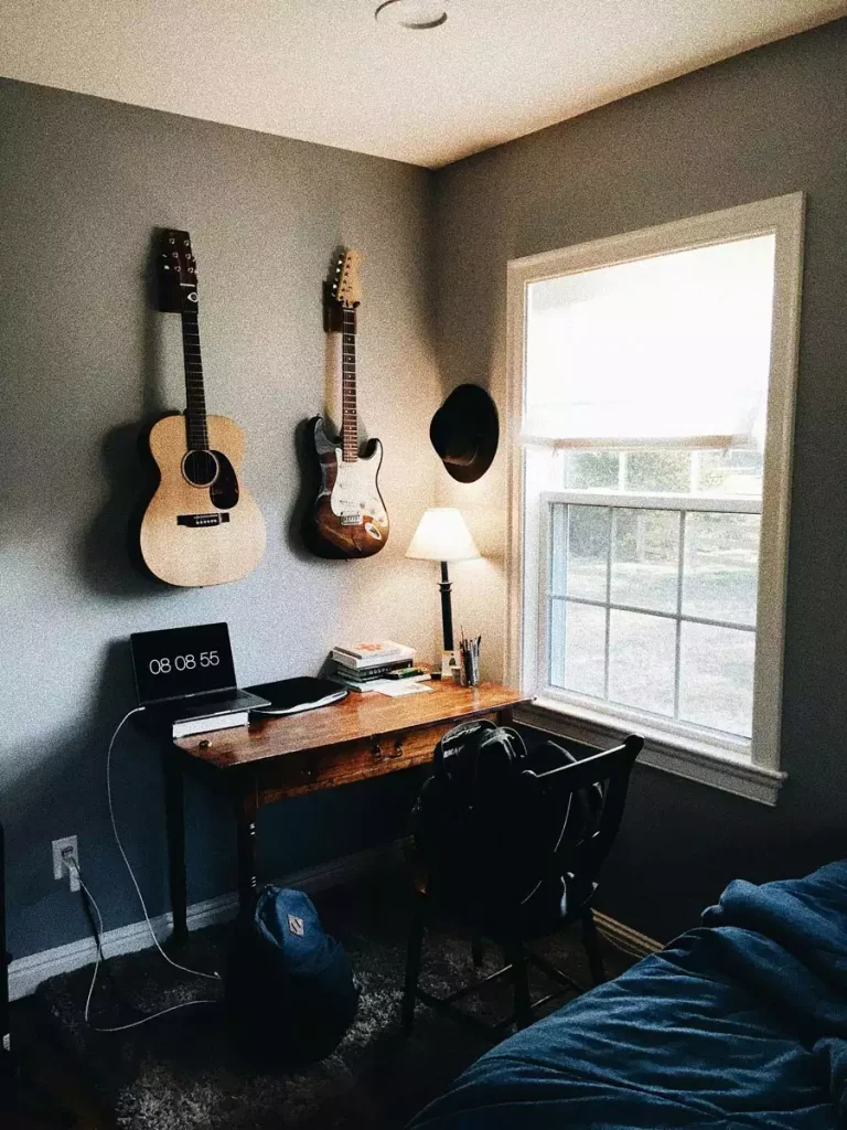 Wall Mounted Guitars Create Music Lover Dorm Wall Decor Above A Wooden Desk Beside A Window