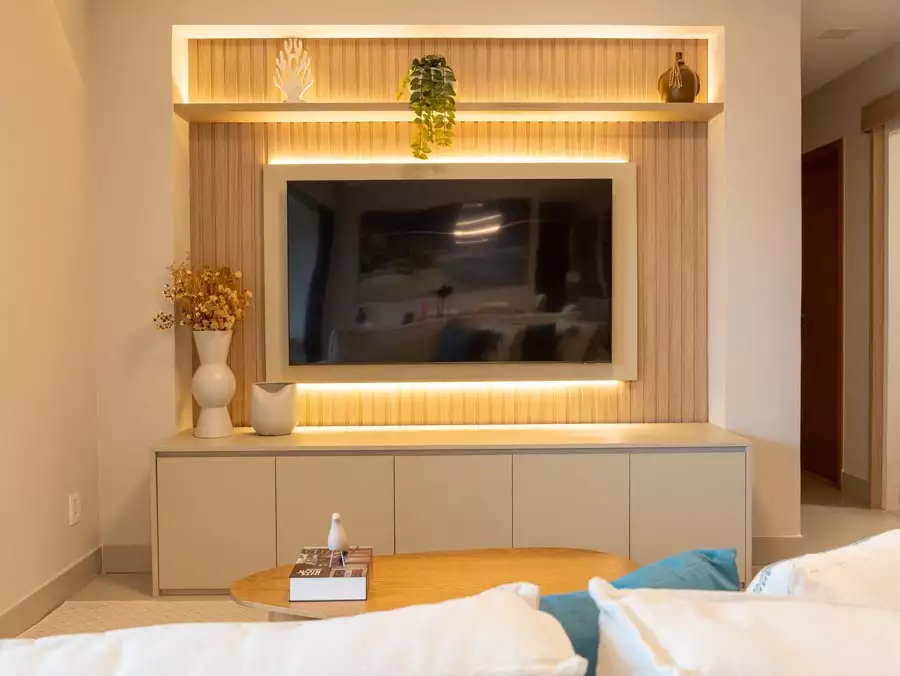 Warm Lit Wood Slat TV Wall With Floating Console And Dried Flower Vase