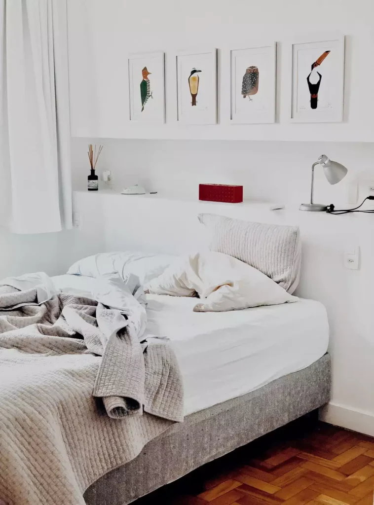 Whimsical bird print series arranged as over the bed wall decor above a floating shelf