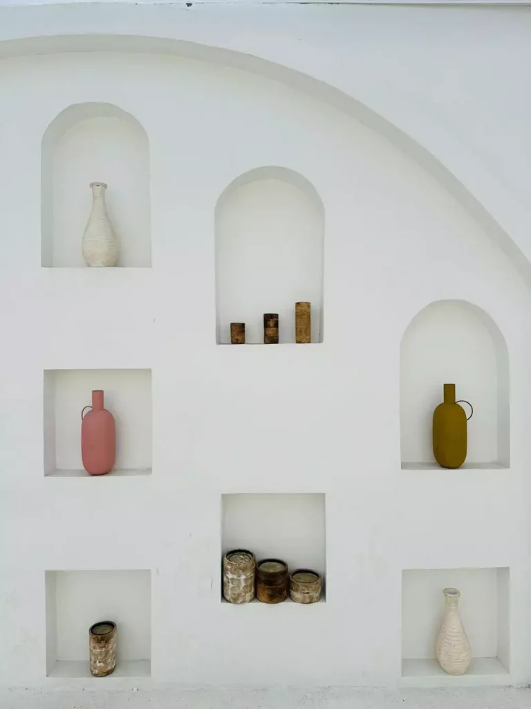 White Wall Arches And Square Niches Each Holding A Single Ceramic Vase