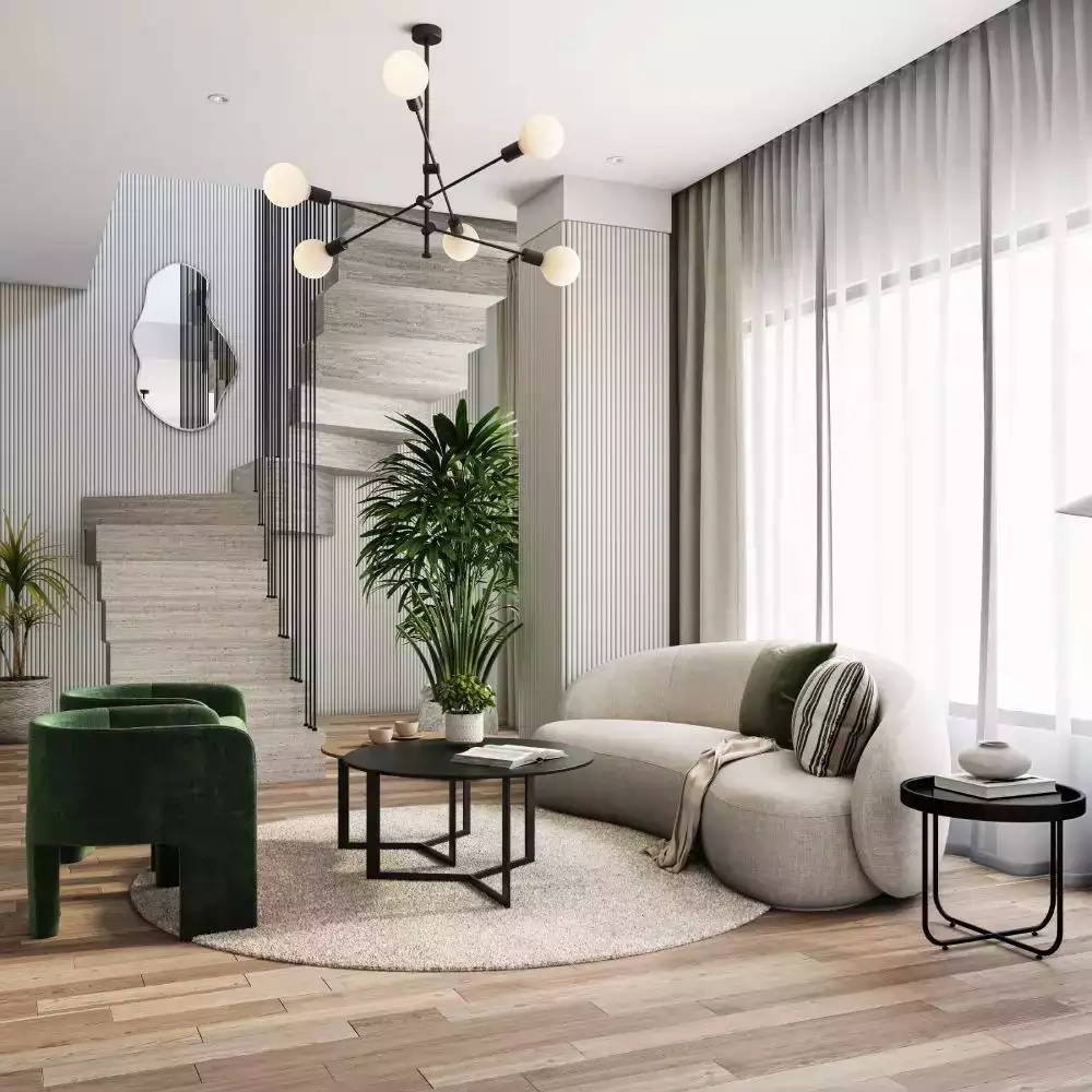 White fluted wall living room, curved sofa, emerald chairs, globe chandelier
