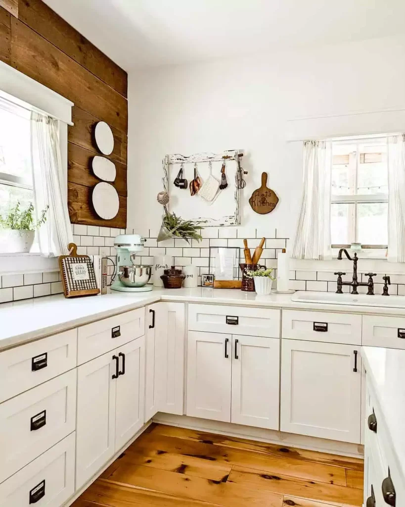 Wood accent kitchen wall with stacked white plates and a hanging utensil rack