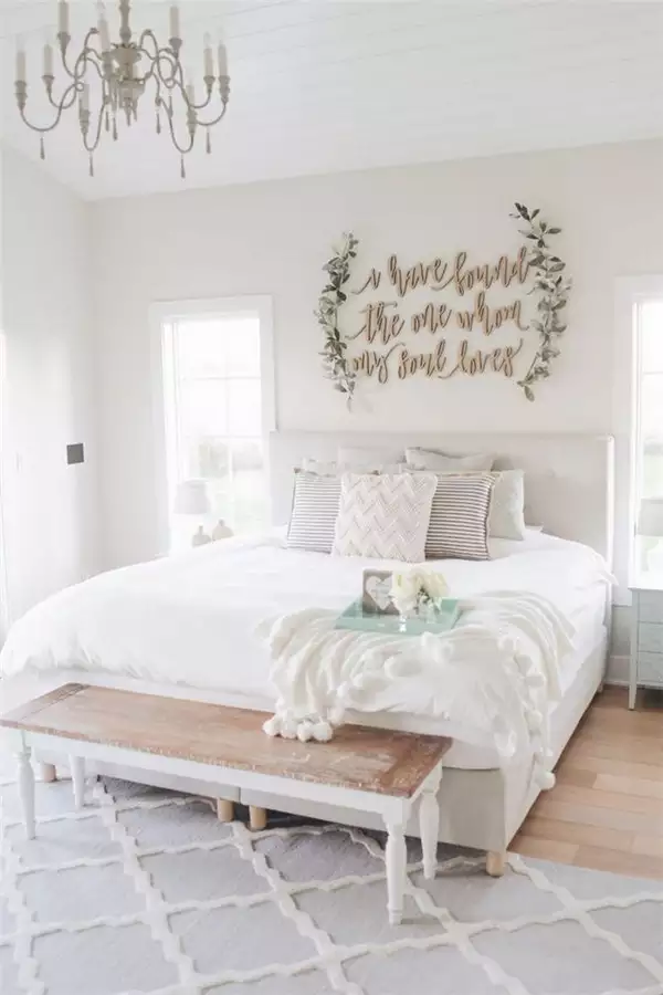 Wood cut script quote wall art as romantic over the bed wall decor above a white bed