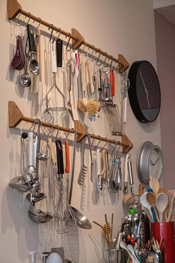 Wooden Wall Rails Loaded With Utensils Offer Functional Kitchen Wall Decor For A Busy Cook