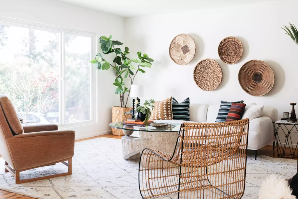 Woven basket wall decor arrangement above white sofa in boho living room