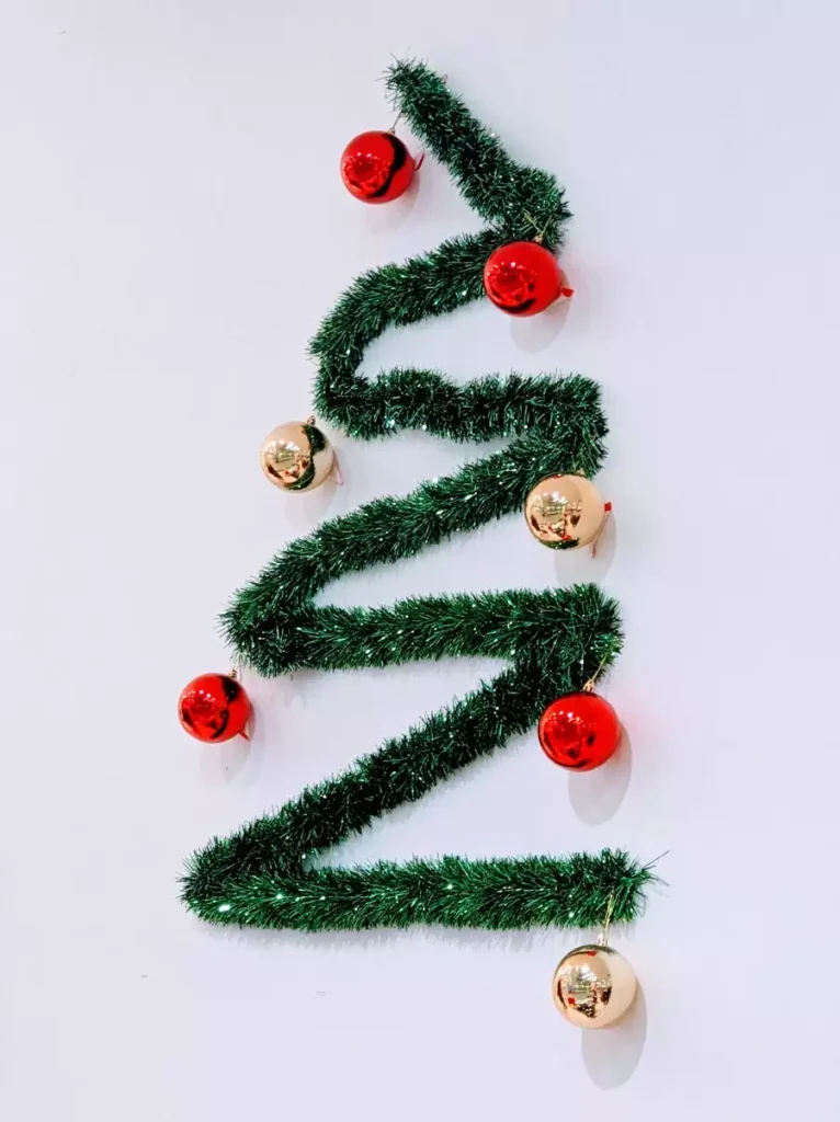 Zigzag Christmas Wall Garland Styled Into A Tree Shape With Red And Gold Ornaments