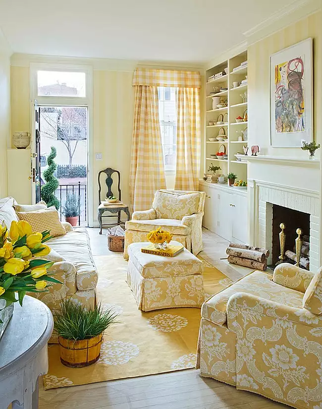 Traditional living room with pale yellow walls, cream furniture, plants, and classic decor