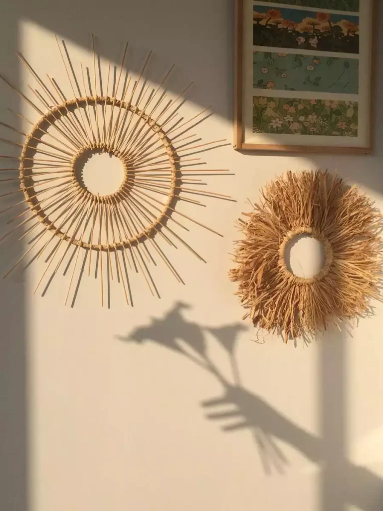 Cane sunburst and fringed wreath on sunlit wall