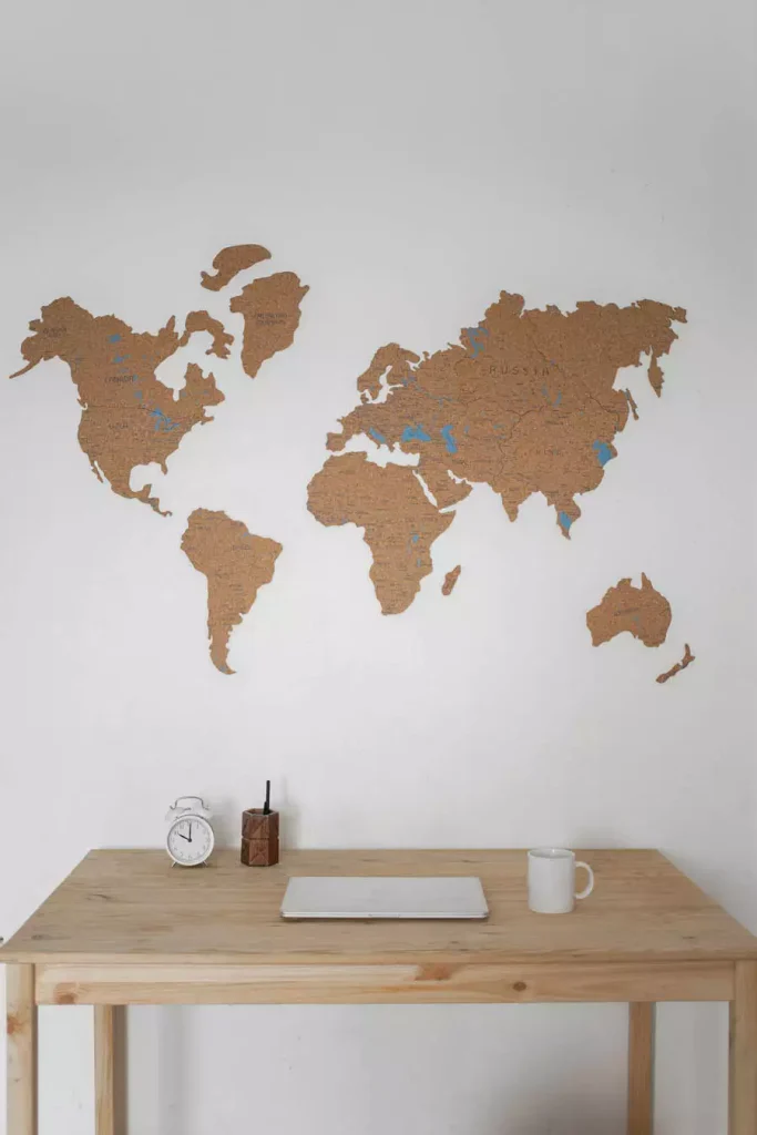 Cork World Map Study Wall Decor Above A Wooden Desk With A Notebook Clock And Mug