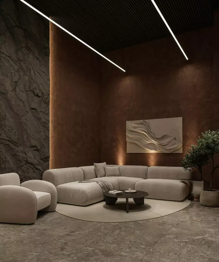 Dark textured feature walls and wave relief artwork behind a curved cream sectional sofa