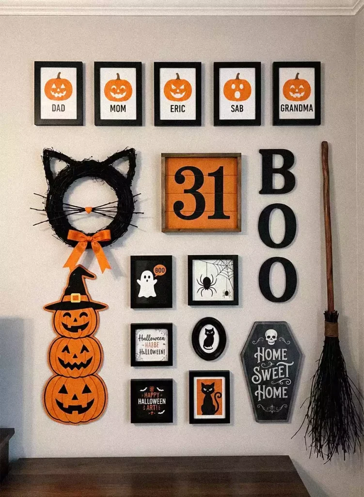 Halloween gallery wall with a black cat wreath, framed prints, stacked pumpkin art, and vertical BOO letters