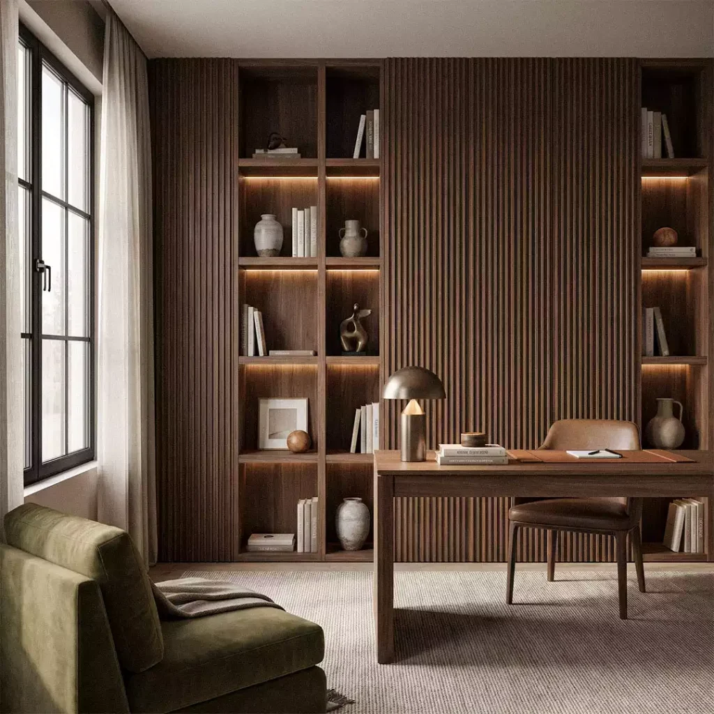 Home office with dark walnut fluted-style wall panels, tall built-in shelves, wooden desk, and olive-green lounge chair