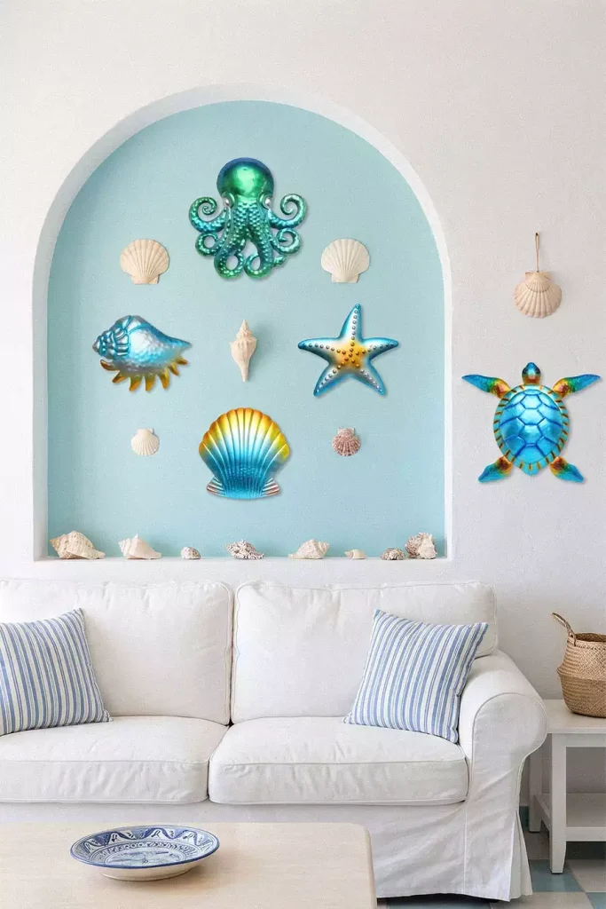 Metallic sea-life wall decorations and seashells inside a blue arch above a white sofa