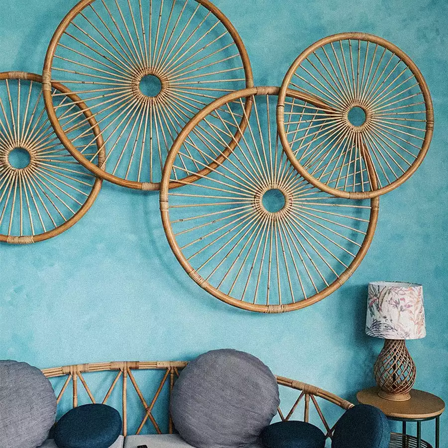 Overlapping rattan spoke circles on turquoise wall