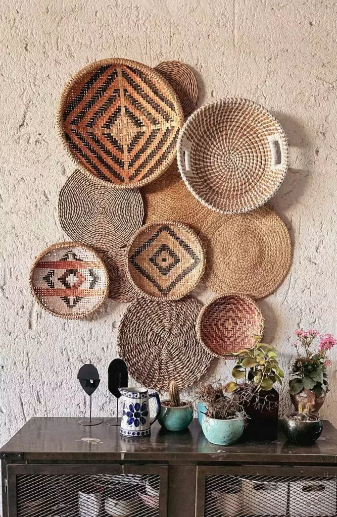 Patterned basket wall decor above metal cabinet and plants
