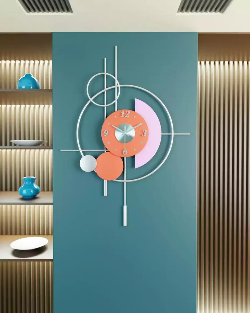 Sculptural wall clock with colorful circles and silver rods on a teal wall