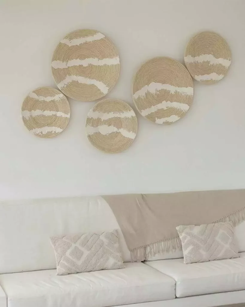 White striped woven wall hangings above white sofa
