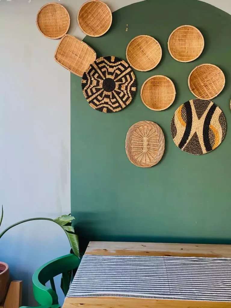 Woven basket wall decor on green dining room arch